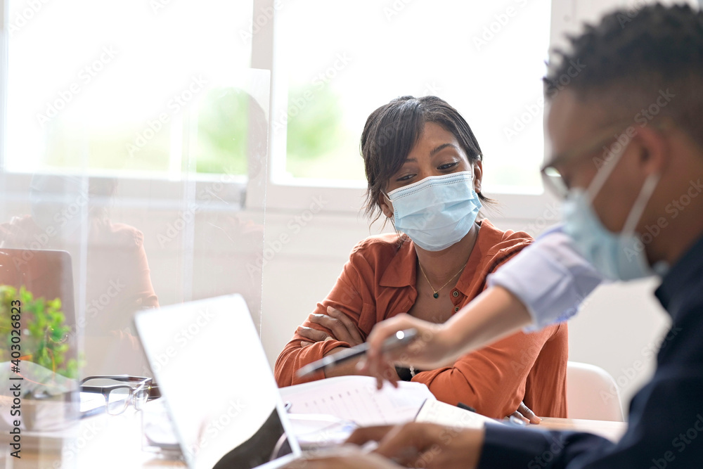 Coworkers in open space office, wearing surgical face mask, 19-ncov pandemic - obrazy, fototapety, plakaty 