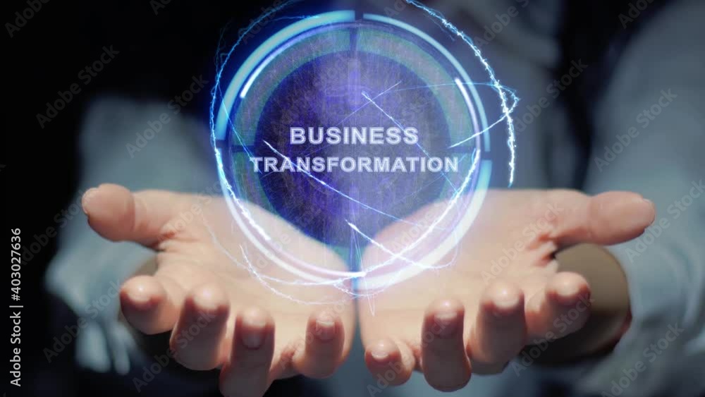 Female hands show a round conceptual hologram with text Business Transformation. Unrecognizable woman in ashen white on a black background with future holographic technology Female hands show a round conceptual hologram with text Business Transformation. Unrecognizable woman in ashen white on a black background with future holographic technology