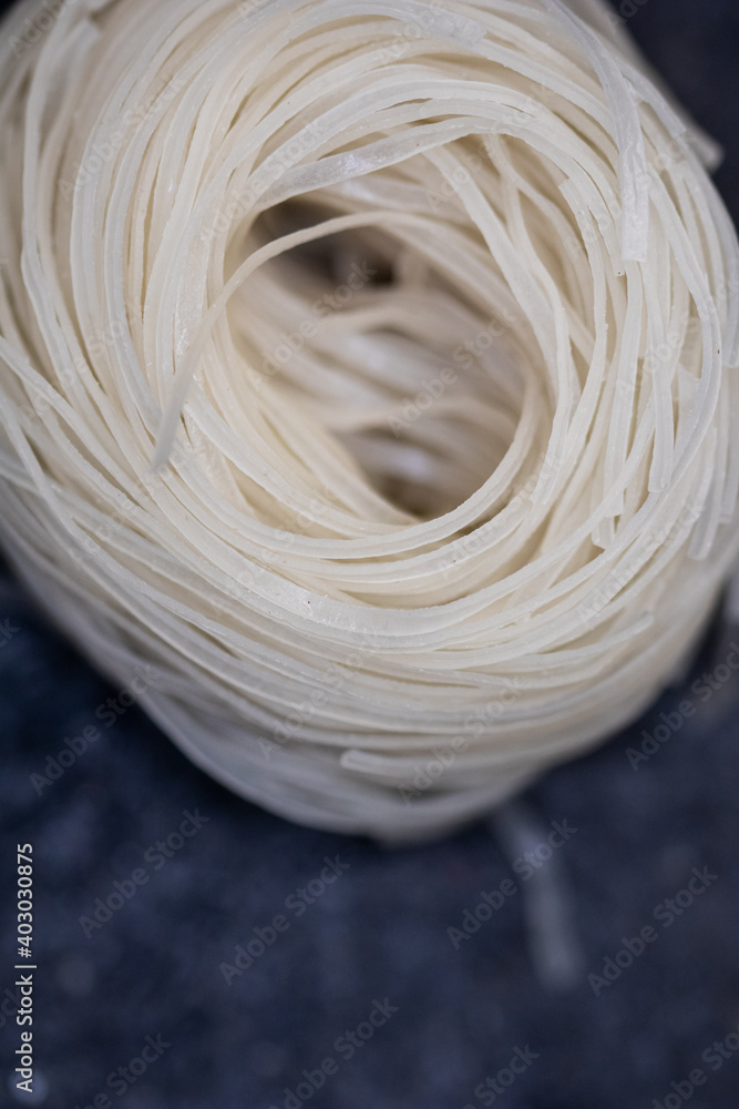 rice noodles nest on black stone background rice noodles nest on black stone background