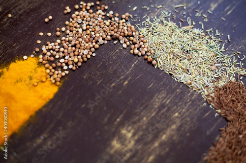 Various spices and seeds on a dark background. Background texture spices with copy space.