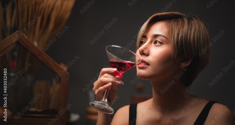 Attractive bartender girl holding in her hands fresh cocktail at the bar counter for celebration Attractive bartender girl holding in her hands fresh cocktail at the bar counter for celebration