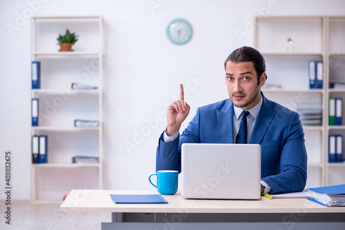 Young male employee working at workplace