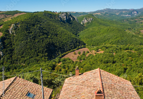 A view of the landscape over rooftops in the historic medieval village of Rocchette di Fazio near Semproniano in Grosseto Province, Tuscany, Italy
 photo
