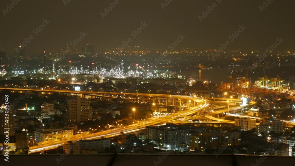Times lapse of light from main road at night in city near river and power plant that also show some ship go along the river. Times lapse of light from main road at night in city near river and power plant that also show some ship go along the river.