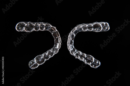 Invisible aligner teeth retainers on a black background