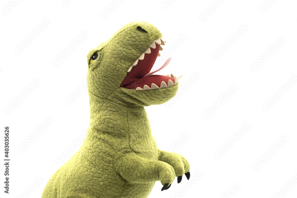 Obraz premium Closeup of green dinosaur plush standing on white background