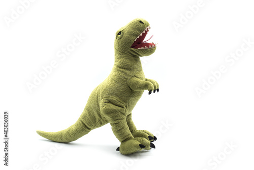 Closeup of green dinosaur plush standing on white background