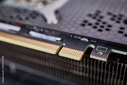 PCI express PCIe connector detail on a high end graphics card with metal backplate heatsink