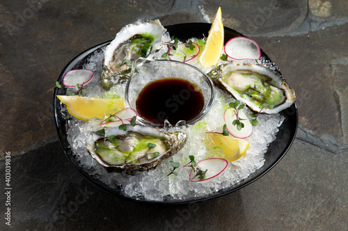 Fresh oysters on ice. In a plate