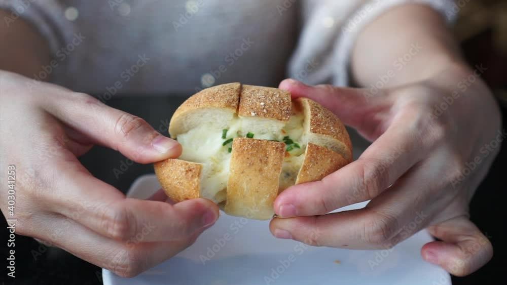 Hand picking fresh baked Korean cheese bread melted Hand picking fresh baked Korean cheese bread melted