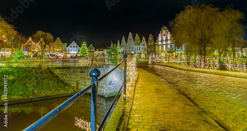 View of festive lighting and Christmas romantic atmosphere in Friedrichstadt at night. Nighttime view of Friedrichstadt  at Christmas, New Year time, Schleswig-Holstein, Germany, Europe. photo