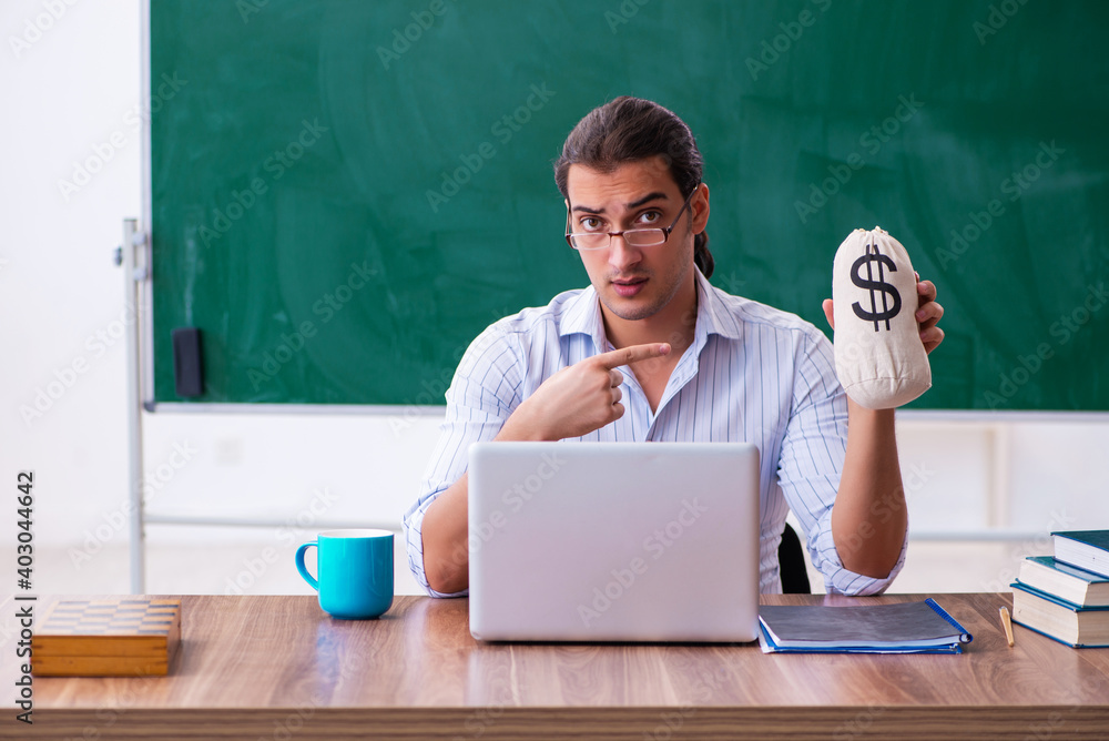 Young male teacher in remuneration concept Young male teacher in remuneration concept