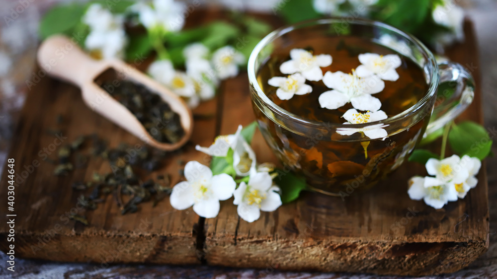 Selective focus. Fresh jasmine tea in a cup with jasmine flowers. Selective focus. Fresh jasmine tea in a cup with jasmine flowers.