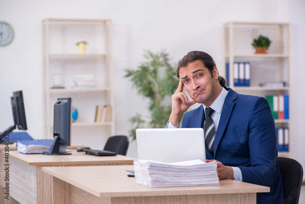 Young male employee working in the office Young male employee working in the office