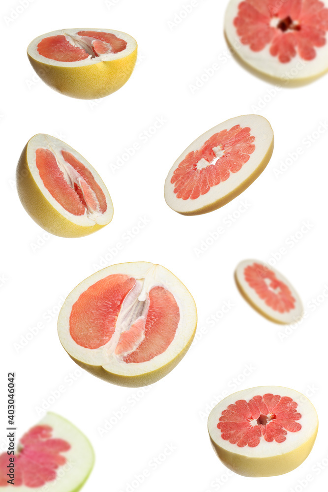 Fresh exotic pomelo fruits falling on white background Fresh exotic pomelo fruits falling on white background