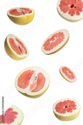 Fresh exotic pomelo fruits falling on white background