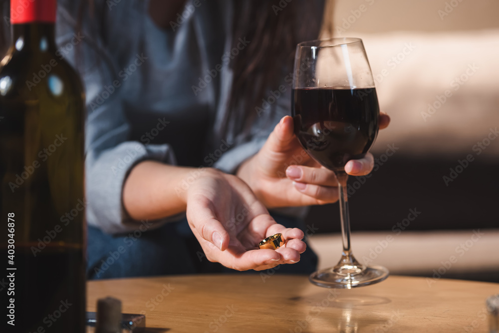 selective focus of alcoholic woman holding coins and glass of red wine selective focus of alcoholic woman holding coins and glass of red wine