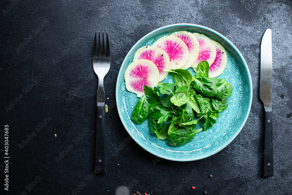 fresh salad Watermelon radish chinese daikon Slices of pink fruit, green leaves, spinach, lettuce ready to eat on the table healthy meal snack top view copy space food background keto or paleo diet fresh salad Watermelon radish chinese daikon Slices of pink fruit, green leaves, spinach, lettuce ready to eat on the table healthy meal snack top view copy space food background keto or paleo diet