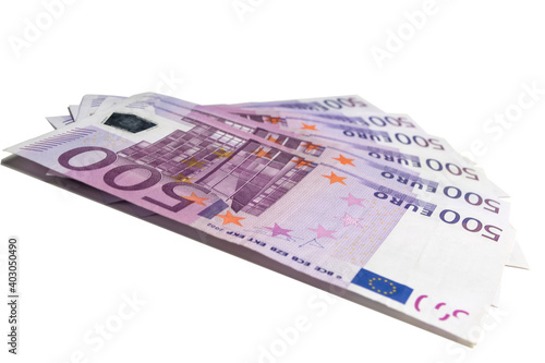 500 Euro bills arranged in a fan in a low angle view on white background