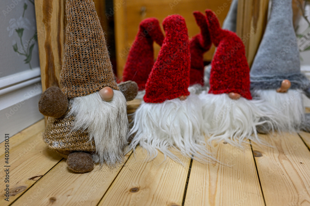 Obraz premium small Santas made of cloth standing on wooden floor