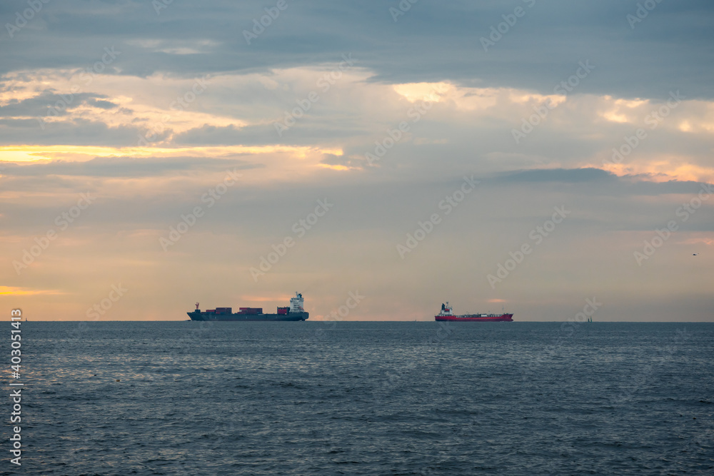Logistics import export Container Cargo ship in seaport on sunset sky, Freight Transportation by container ship boat