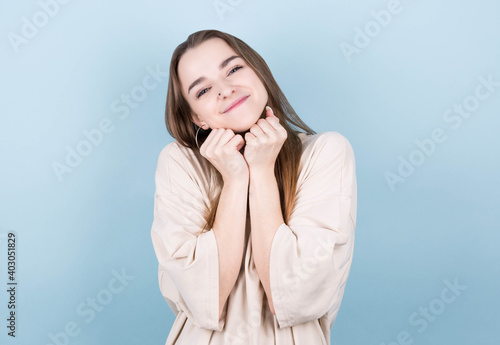 Happy cheerful young brunette teen looking at camera with joyful and charming smile. © MP Studio