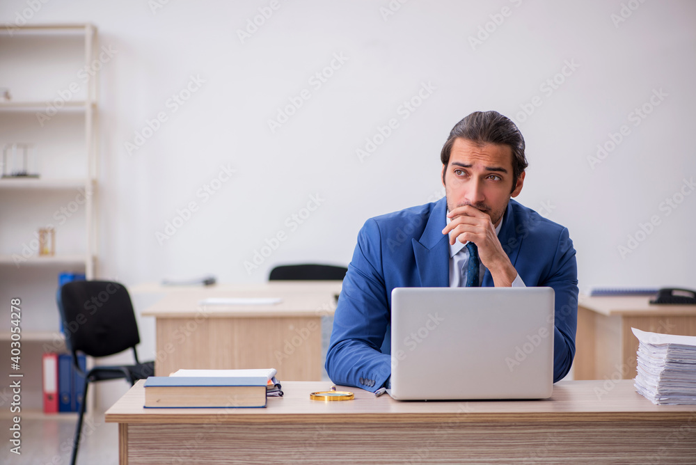 Young male employee and too much work in the office Young male employee and too much work in the office