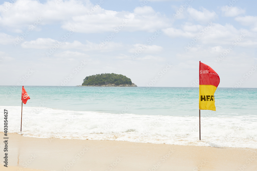 View of warning flag on nice warm tropic beach during law season