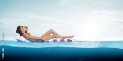 view of nice young lady chilling on inflatable mattress in tropical site