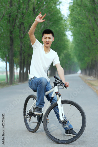 A young man riding bicycle in the park 