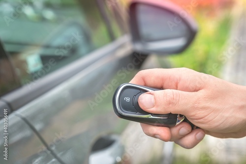 Woman lock or unlock her car with car remote control