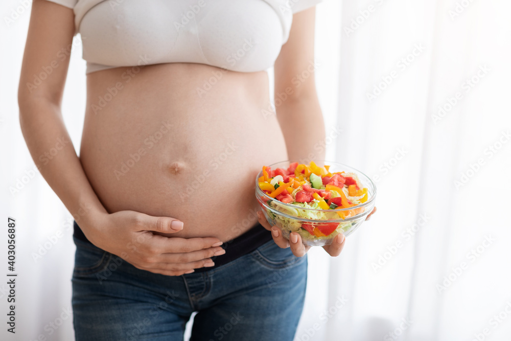 Healthy Food For Future Baby. Pregnant Woman Holding Bowl With Vegetable Salad Healthy Food For Future Baby. Pregnant Woman Holding Bowl With Vegetable Salad
