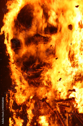 Burning sculpture made with paper mache with human face look alike in burning process
