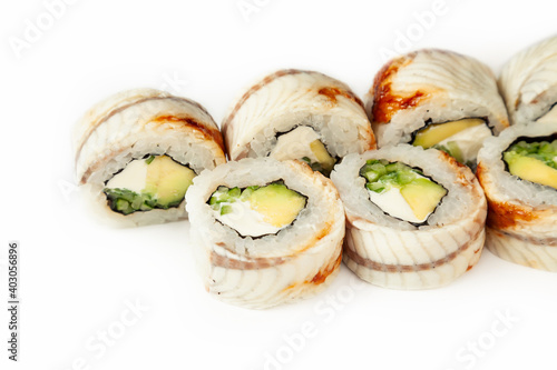 Sushi roll Black dragon on a white background, ingredients Eel, cream cheese, avocado, cucumber, teriyaki sauce, sesame seeds, rice, nori. Traditional Japanese food. For the restaurant menu