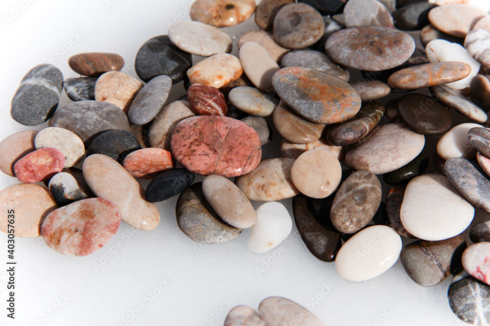 Background from multi-colored stones. Texture of sea stones. Red and blue pebbles. Stone beach. Minerals. Colorful stone. Semiprecious stones. Stereoscopic Cobblestone. Background from multi-colored stones. Texture of sea stones. Red and blue pebbles. Stone beach. Minerals. Colorful stone. Semiprecious stones. Stereoscopic Cobblestone.