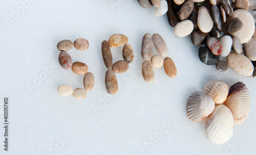 Sea pebble lettering  SPA. Marine background with seashells.