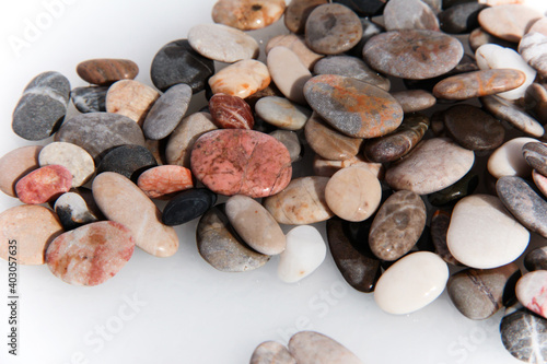 Background from multi-colored stones. Texture of sea stones. Red and blue pebbles. Stone beach. Minerals. Colorful stone. Semiprecious stones. Stereoscopic Cobblestone.