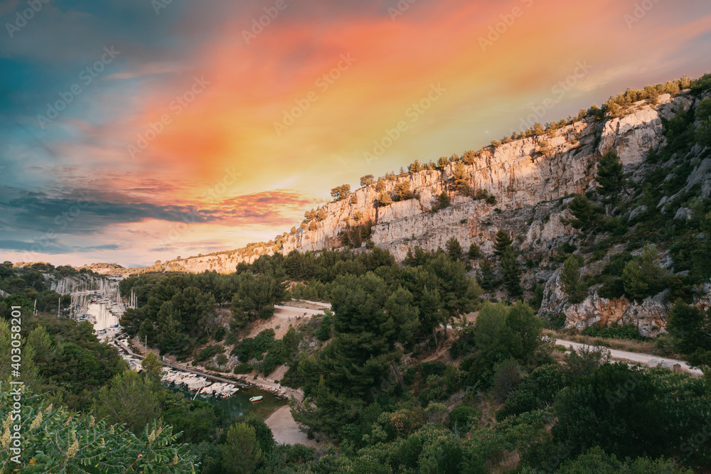 Cassis, Calanques, France. French Riviera. Beautiful Nature Of Cote De Azur On The Azure Coast Of France. Calanques - A Deep Bay Surrounded By High Cliffs. Altered Sunset Sky