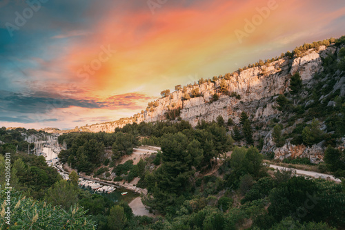 Cassis, Calanques, France. French Riviera. Beautiful Nature Of Cote De Azur On The Azure Coast Of France. Calanques - A Deep Bay Surrounded By High Cliffs. Altered Sunset Sky
