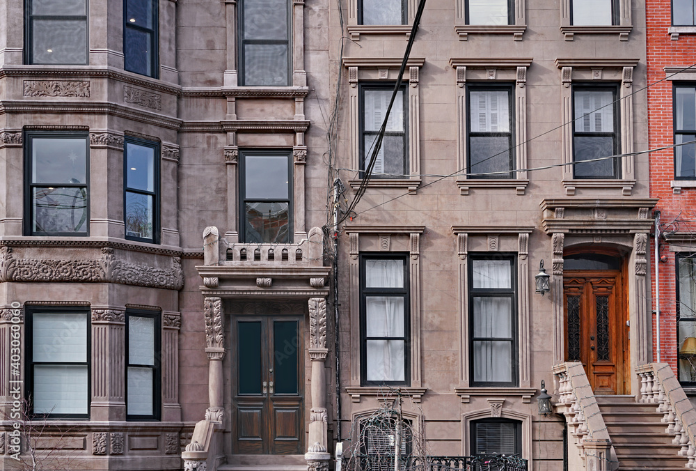 facades of old brownstone style apartment buildings