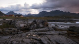 rocky coast of the north sea in Norway on the Lofoten Islands against the backdrop of mountains and fishing village