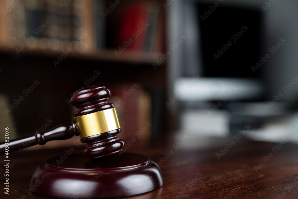 Law theme. Judge chamber. Judge’s gavel on brown desk. Collection of