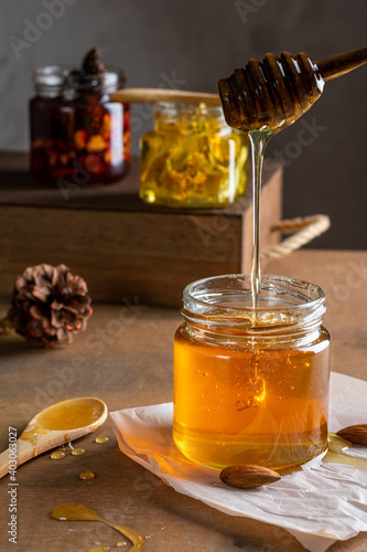 Three jars of honey on a wooden table