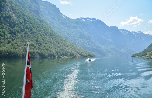 Amazing nature view with blue waters and tree covered rocks  jutting out of water one of the most beautiful fjords in Norway, Sognefjord  © Dmytro