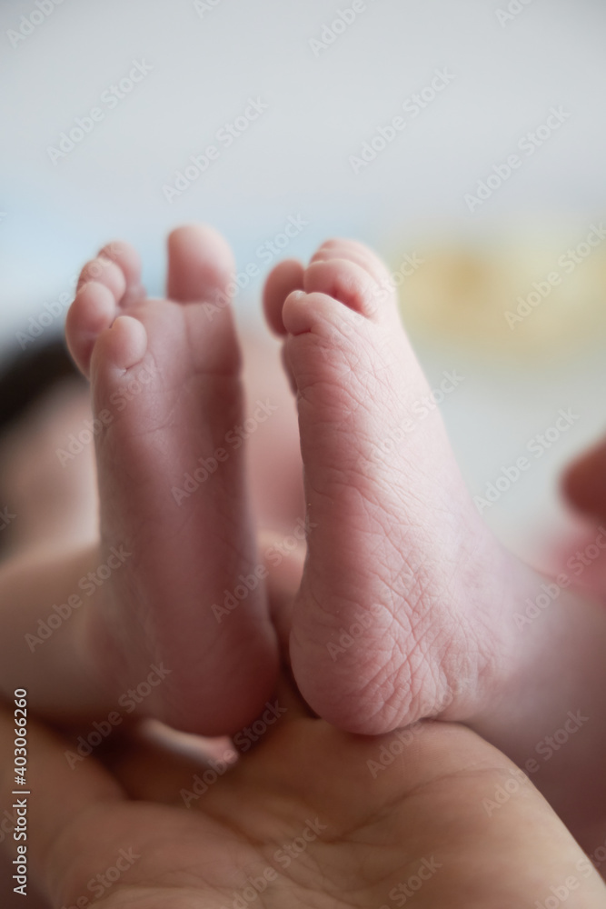 Small feet of a newborn close up. The first days of a baby's life. Small feet of a newborn close up. The first days of a baby's life.