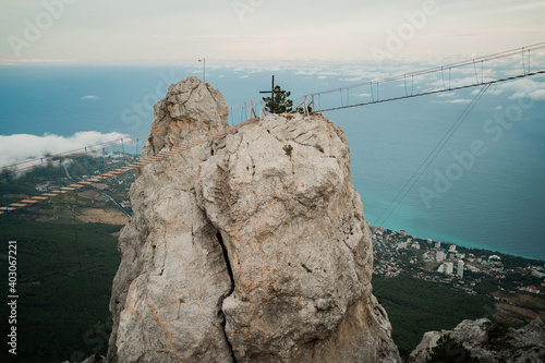high view background on the sea and blue sky  panorama  space to copy. travel in the mountains  dangerous suspension bridge cable car between two rocks.