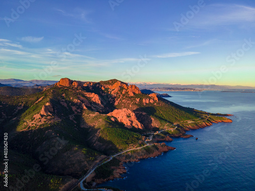 Massif de l'Esterel Aerial view during sunset, showing Cannes in the background with blue sky showing pine tree forest in the French Riviera, close to Cannes in Côte d'Azur, South of France
