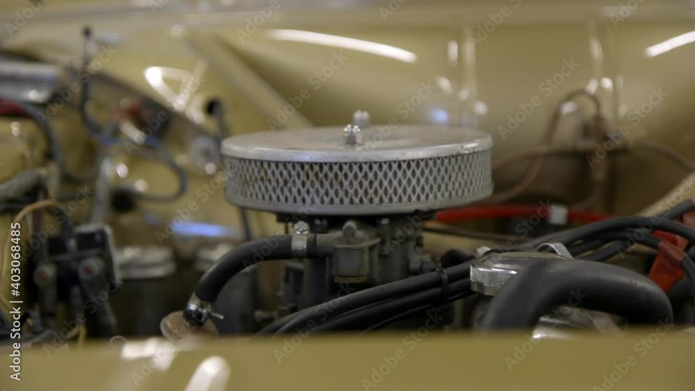 Close up sliding shot of exposed engine of a British classic car. Slow motion Close up sliding shot of exposed engine of a British classic car. Slow motion