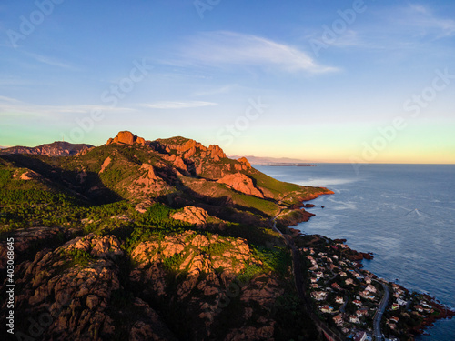 Massif de l'Esterel Aerial view during sunset, showing Cannes in the background with blue sky showing pine tree forest in the French Riviera, close to Cannes in Côte d'Azur, South of France