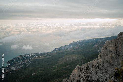 Travel in nature there are dangerous big rock with a sharp cliff. high beautiful view of Mount Athos on the sea and blue sky, panorama, space to copy.